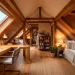Cozy attic converted into a modern guest room and home office combo with skylights and exposed beams.