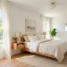 A bright and airy small guest room with white linens, sheer curtains, and natural light creating an open feel.