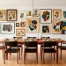 A wide view of a mid-century modern dining room featuring a stunning gallery wall above a teak credenza.