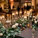 Luxurious DIY wedding tablescape with eucalyptus runner, white roses, and floating candles