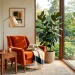 Mid-century modern reading nook featuring a burnt orange velvet chair and walnut table beside a sunny window.