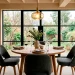 Wide view of a modern dining room featuring a warm oak round table and stylish chairs
