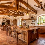 Stunning Mediterranean kitchen featuring warm reclaimed wood beams, terracotta floors, and elegant wrought iron lighting.