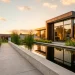 Sleek modern geometric pond reflecting a contemporary backyard patio during golden hour