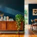 Wide view of a beautiful mid-century modern walnut sideboard in a stylish dining room with navy walls