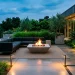 Luxurious modern minimalist patio at twilight with concrete fire pit and modular seating