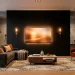 Modern living room with a matte black TV wall illuminated by warm bias lighting and brass sconces.