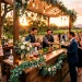 Beautiful outdoor wedding bar setup at golden hour serving colorful signature cocktails.
