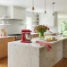 Bright modern kitchen decorated for Memorial Day featuring striking bold red accents and natural sunlight.