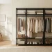Minimalist dressing room featuring an open wardrobe, neutral color palette, and soft natural lighting