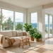 Bright Scandinavian style sunroom with large windows, white walls, and cozy linen seating.