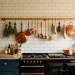 Solid brass herb rail mounted on a traditional kitchen backsplash above a vintage stove