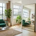 Bright and stylish studio apartment showcasing multi-functional furniture and large mirrors.