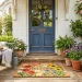 Brightly painted floral coir doormat on a sunny summer front porch with potted plants