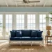 Bright coastal blue sunroom featuring wicker furniture and ocean-toned decor with natural light