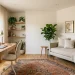 A beautifully styled dual-purpose home office and guest room featuring a daybed and modern desk setup.