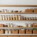 Beautifully organized Scandinavian pantry with light wood shelves, glass storage jars, and clean lines.