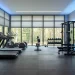 Modern home gym setup with smart thermostat, bladeless fan, and cellular window shades for year-round comfort.