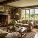 Cozy English country cottage living room with a roaring fireplace and overstuffed floral linen sofas