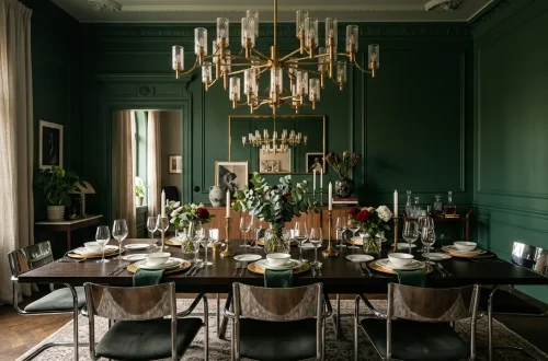 Luxurious green dining room decorated with sparkling brass, copper, and silver metallic accents