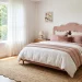 Beautiful modern bedroom featuring a pink scalloped headboard and wavy jute rug