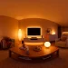 Cozy living room illuminated by warm ambient lighting fixtures creating a relaxing evening vibe