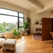 A stylish studio apartment featuring a mid century wooden cabinet that hides a home office setup