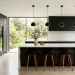 Luxurious seamless modern kitchen design featuring flat-panel cabinetry and a white quartz waterfall island.