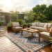 A beautiful patio featuring a weather-resistant outdoor rug handling rain and bright sun perfectly.