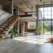 Modern staircase with industrial-chic matte black vertical steel rods and natural oak treads in a brightly lit loft