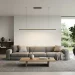 Wide minimalist living room interior showcasing a sleek linear LED pendant light over a modern gray sofa.