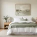 Serene modern bedroom featuring soft sage green decor accents like a linen throw, accent pillows, and a ceramic vase.