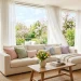 Bright spring living room with a cozy cream sofa featuring blush pink, sage green, and powder blue pastel throw pillows.