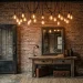 Industrial entryway featuring a cluster of amber Edison bulbs hanging over a rustic wood console table.