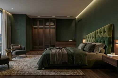 Luxurious modern 2026 bedroom with deep green walls and an oversized velvet headboard