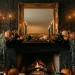 Halloween mantel decor featuring perfectly layered heights, tall black candles, and a vintage gold mirror