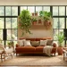 Cozy earthy living room decorated with vibrant houseplants, terracotta pots, and natural fiber furniture