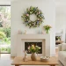 Beautifully decorated living room with an Easter wreath hanging flawlessly above a mantel.