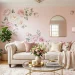 Girly apartment living room styled with oversized floral wall decals and a plush velvet cream sofa.
