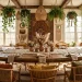 Warm bohemian dining room featuring rustic wooden table, macramé runner, and hanging plants.