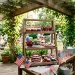 A beautifully styled three-tier wooden stand filled with Memorial Day desserts on an outdoor patio table.