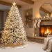 Beautiful all-white monochromatic Christmas tree decorated with textured ornaments in a cozy modern living room.