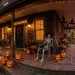Atmospheric Halloween porch decorated with glowing pumpkins, floating witch hats, and a posed skeleton at dusk