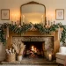 Beautifully layered Valentine's Day mantel decor featuring blush pink accents, glowing candles, and lush greenery.