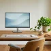 Aesthetic minimalist desk setup with oak wood and zero visible cables bathed in soft natural sunlight.
