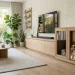 Sleek white oak media console serving as a modern minimalist dog crate in a bright living room.