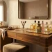 Luxurious mirrored vanity tray displaying elegant perfume bottles on a modern bedroom dresser