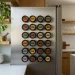 Modern kitchen with magnetic spice tins arranged beautifully on a stainless steel refrigerator door, decluttering the space.