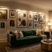 Elegant modern living room featuring a gallery wall illuminated by brass rechargeable picture lights over framed artwork.