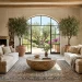 A bright Mediterranean style living room featuring a textured faux stone coffee table and cream linen sofas.